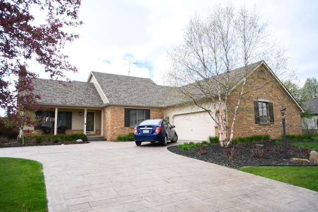 ranch-style home featuring driveway, a shingled roof, brick siding, and an attached garage