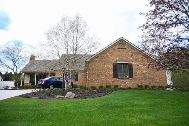 single story home featuring a front lawn, brick siding, driveway, and a chimney