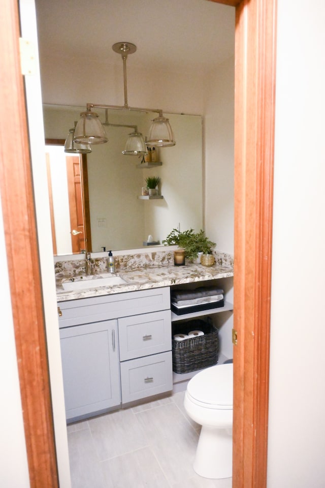 bathroom featuring toilet and vanity