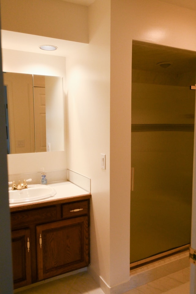 bathroom with vanity, a shower stall, and tile patterned flooring
