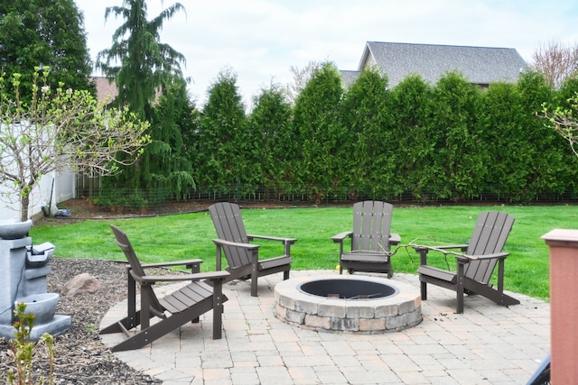 view of patio with a fire pit and fence