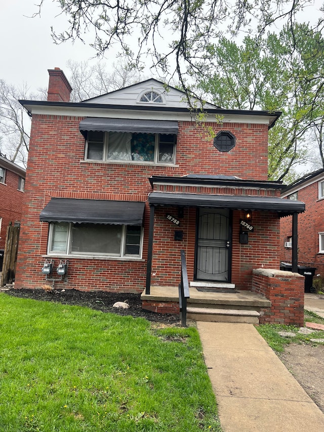 15758 Hubbell St, Detroit, MI 48227 - view of front of home featuring brick siding, a chimney, and a front lawn