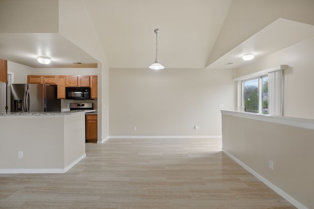 kitchen with appliances with stainless steel finishes, decorative light fixtures, baseboards, vaulted ceiling, and light wood-type flooring