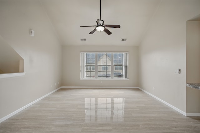 unfurnished room featuring lofted ceiling, a ceiling fan, and visible vents