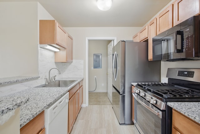 kitchen with stainless steel range with gas cooktop, a sink, black microwave, backsplash, and white dishwasher
