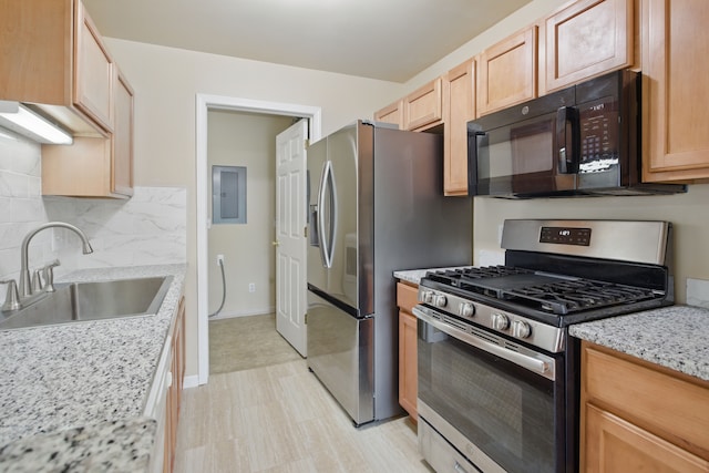 kitchen featuring a sink, electric panel, black microwave, gas range, and decorative backsplash