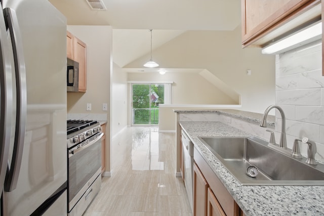 kitchen with a sink, visible vents, light brown cabinets, hanging light fixtures, and appliances with stainless steel finishes