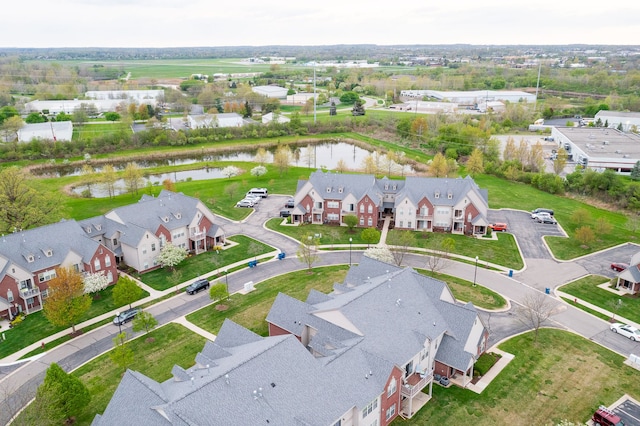 birds eye view of property featuring a water view and a residential view