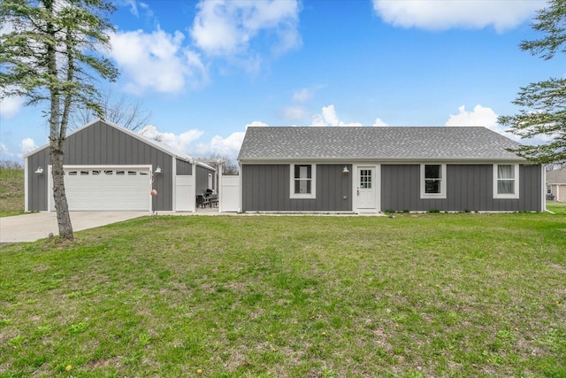23174 County Road 354, Lawton, MI 49065 - single story home with a front yard, roof with shingles, board and batten siding, concrete driveway, and an outbuilding