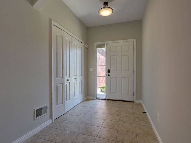 entrance foyer featuring light tile patterned flooring, baseboards, and visible vents
