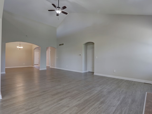 unfurnished living room featuring ceiling fan, high vaulted ceiling, baseboards, wood finished floors, and visible vents