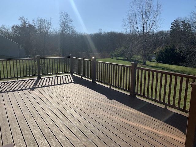 wooden deck with a lawn