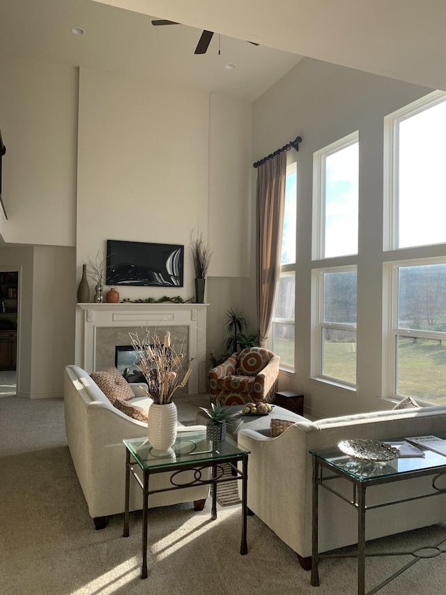 carpeted living room featuring recessed lighting, ceiling fan, and a premium fireplace