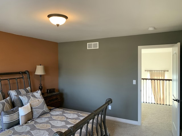 bedroom featuring baseboards, carpet flooring, and visible vents