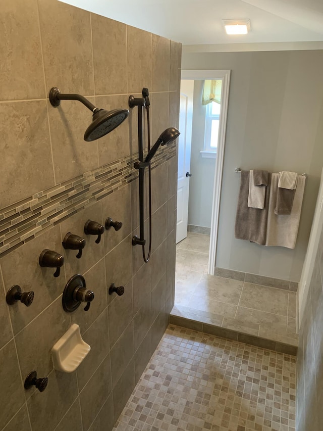 bathroom with tile patterned floors and a tile shower