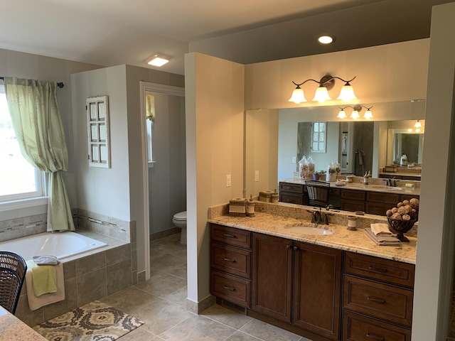 full bathroom featuring a bath, toilet, tile patterned flooring, and vanity