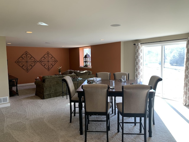 carpeted dining space with recessed lighting and visible vents