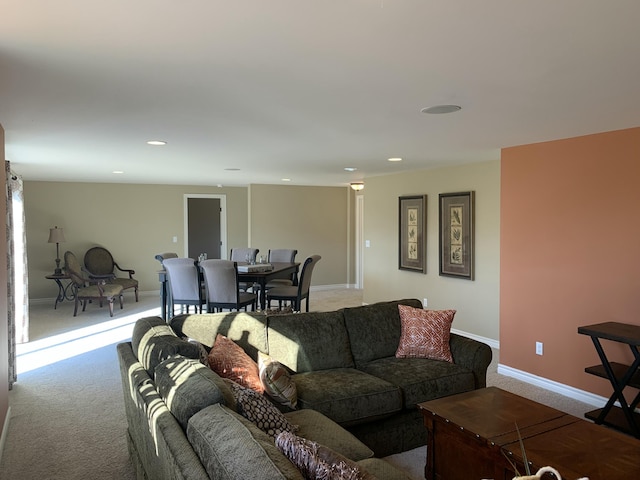 carpeted living area with recessed lighting and baseboards