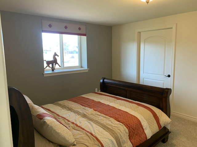 bedroom with carpet floors and baseboards