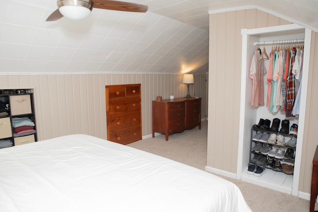 bedroom featuring lofted ceiling, carpet flooring, a closet, and ceiling fan