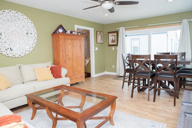 living area featuring baseboards, recessed lighting, light wood-style flooring, and ceiling fan