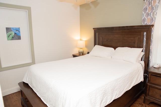 bedroom with wood finished floors and baseboards