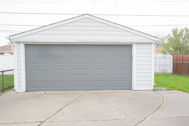 detached garage featuring fence