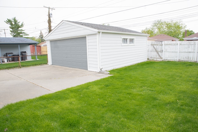 detached garage featuring fence
