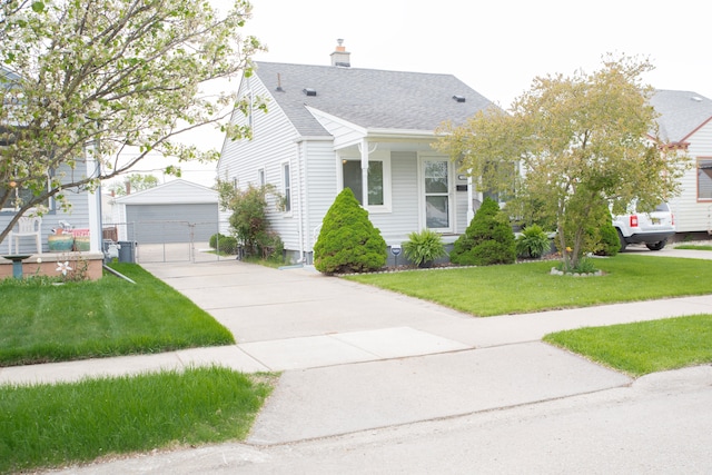 view of front of property featuring roof with shingles, an outdoor structure, a garage, a front lawn, and a chimney