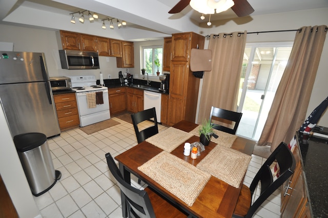 1506 E Windemere Ave, Royal Oak, MI 48073 - kitchen with light tile patterned flooring, dark countertops, stainless steel appliances, a ceiling fan, and a tray ceiling