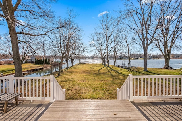 deck featuring a lawn and a water view