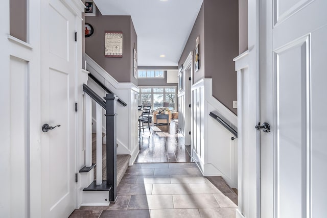 foyer featuring recessed lighting, tile patterned floors, and a decorative wall