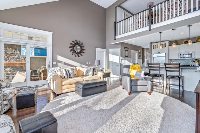 living room featuring high vaulted ceiling and dark wood-style floors