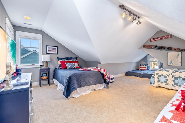 bedroom featuring multiple windows, light carpet, vaulted ceiling, and visible vents