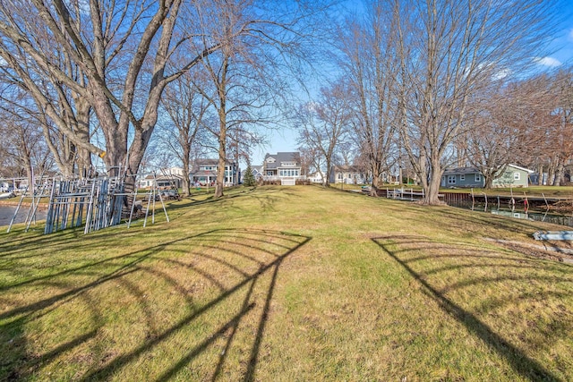 view of yard featuring playground community and a residential view