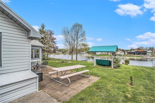 view of yard featuring a water view and a patio