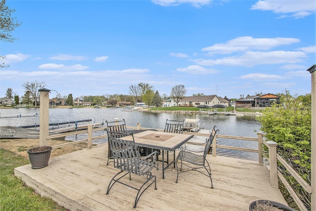 view of dock with a water view, a residential view, and outdoor dining space