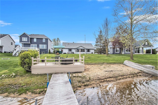 view of dock featuring a yard and a deck
