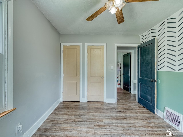 unfurnished bedroom featuring baseboards, visible vents, and light wood-style flooring