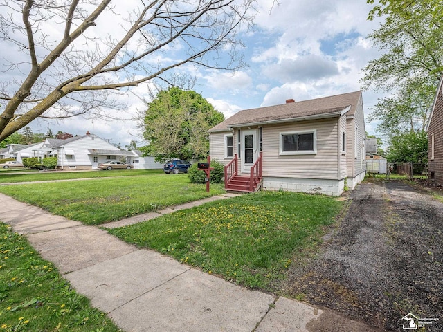 bungalow-style home with fence, a chimney, and a front yard