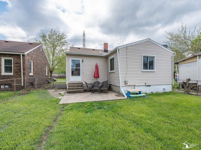 rear view of house featuring a patio area, fence, a yard, and crawl space