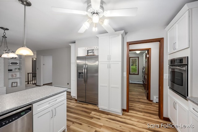 kitchen featuring ceiling fan, stainless steel appliances, light wood finished floors, and a baseboard heating unit