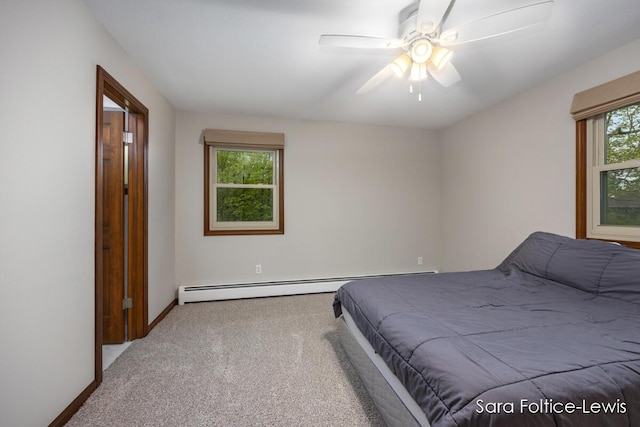 carpeted bedroom with a baseboard radiator, baseboards, and a ceiling fan