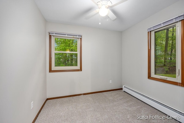 unfurnished room with baseboards, a baseboard radiator, ceiling fan, and carpet
