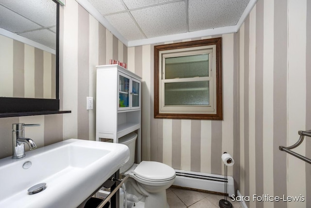 bathroom with wallpapered walls, toilet, a baseboard radiator, and a sink