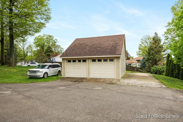 detached garage featuring fence
