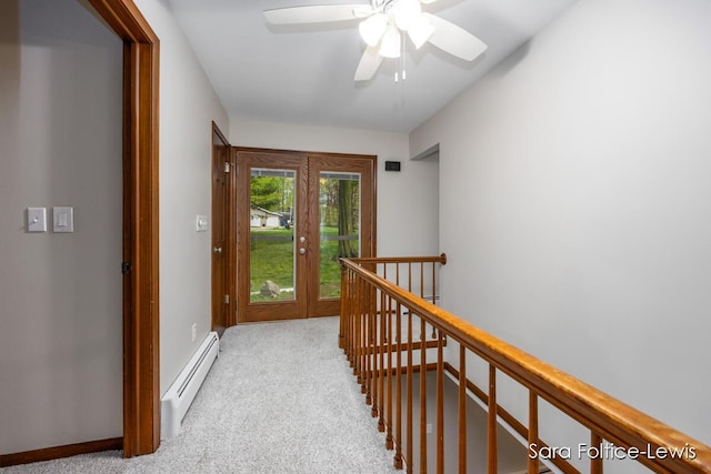 hallway featuring carpet flooring, baseboards, an upstairs landing, and a baseboard radiator