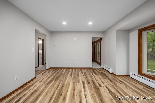 unfurnished living room featuring light wood finished floors, baseboards, a baseboard heating unit, and recessed lighting