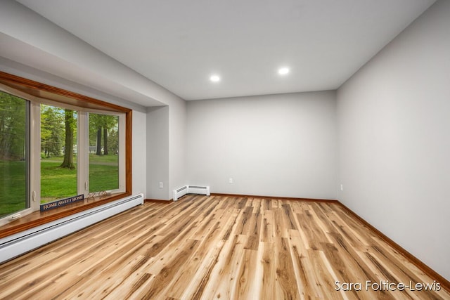 empty room with recessed lighting, baseboards, baseboard heating, and wood finished floors