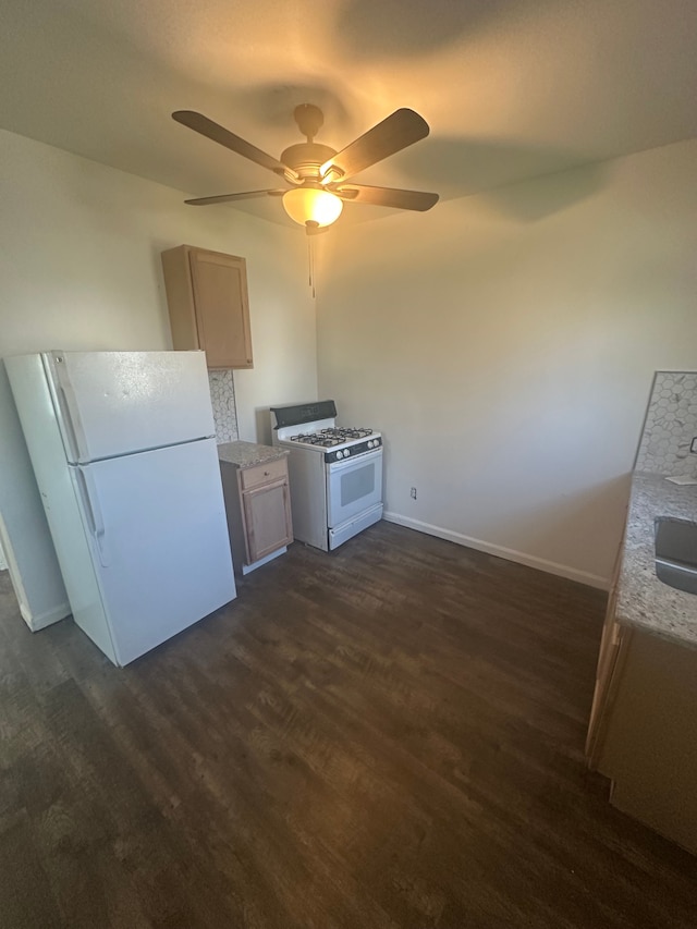 kitchen featuring white appliances, dark wood-style flooring, ceiling fan, and baseboards